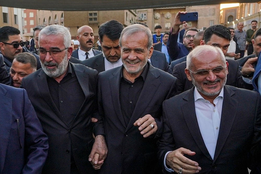 Iran's President Masoud Pezeshkian, center, visits the holy shrine of Imam Ali, in the southern Iraqi city of Najaf, September 12, 2024 (AP)