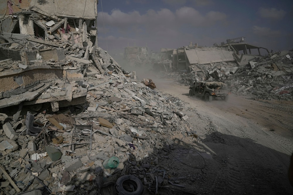 Israeli soldiers drive next to destroyed buildings following Israeli strikes during a ground operation in the Gaza Strip on Friday, September 13, 2024 (AP)