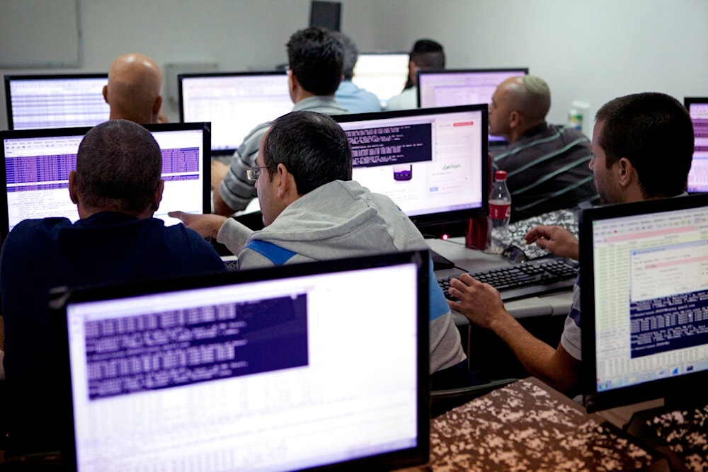 In this undated file photo, Israelis work on computers at the 'CyberGym' school in the coastal city of Hadera, occupied Palestine (AP)