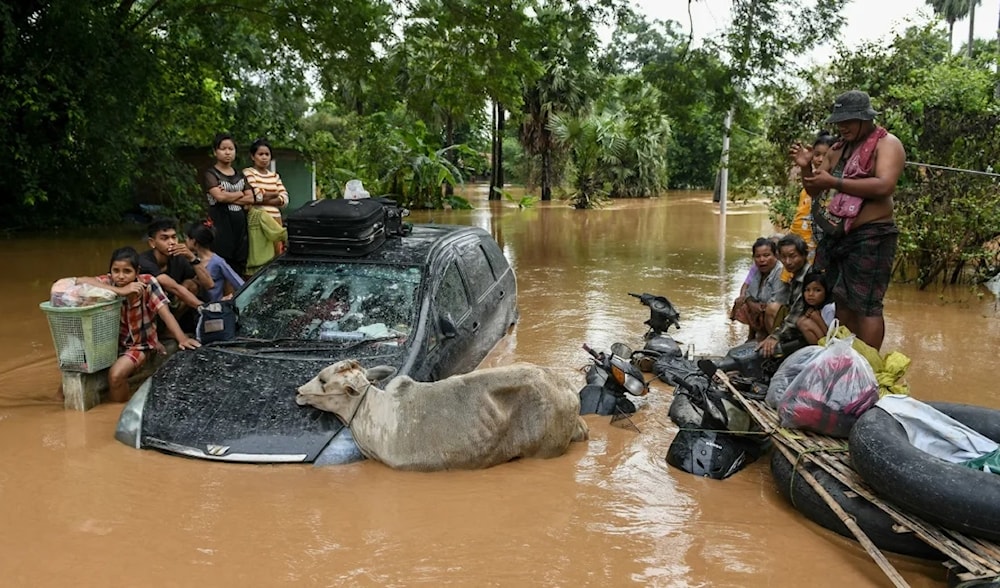 Flood-affected residents wait for a rescue boat to arrive in Taungoo, Myanmar, on September 14, 2024. (AFP)