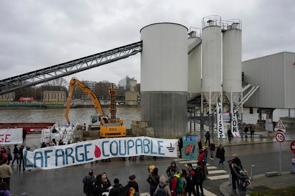 Activists of the environmental group Extinction Rebellion hold a banner reading 