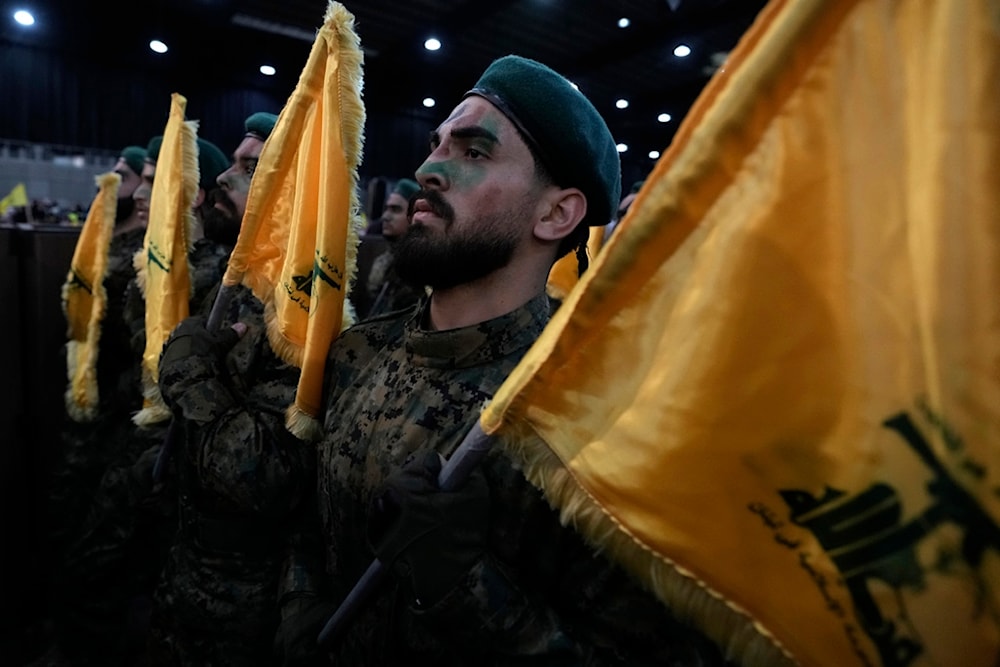 Hezbollah fighters march as they hold flags of Hezbollah during a rally to mark ]Al-Quds day, in a southern suburb of Beirut, Lebanon, Friday, April 5, 2024. (AP)