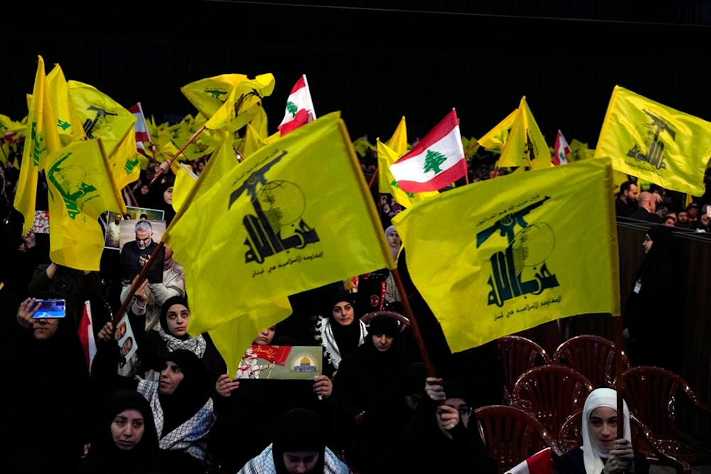 Hezbollah supporters wave Lebanese and Hezbollah flags during a ceremony to mark the third anniversary of the assassination of Iran's Quds force General Qassem Soleimani, Jan. 3, 2023. (AP)