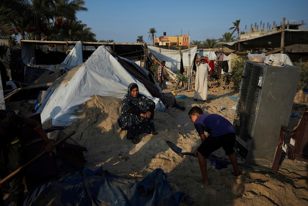 Palestinians look at the destruction after an Israeli occupation airstrike on a tent camp housing Palestinians displaced by the war in Muwasi, Gaza Strip, Palestine, Sept. 10, 2024. (AP)