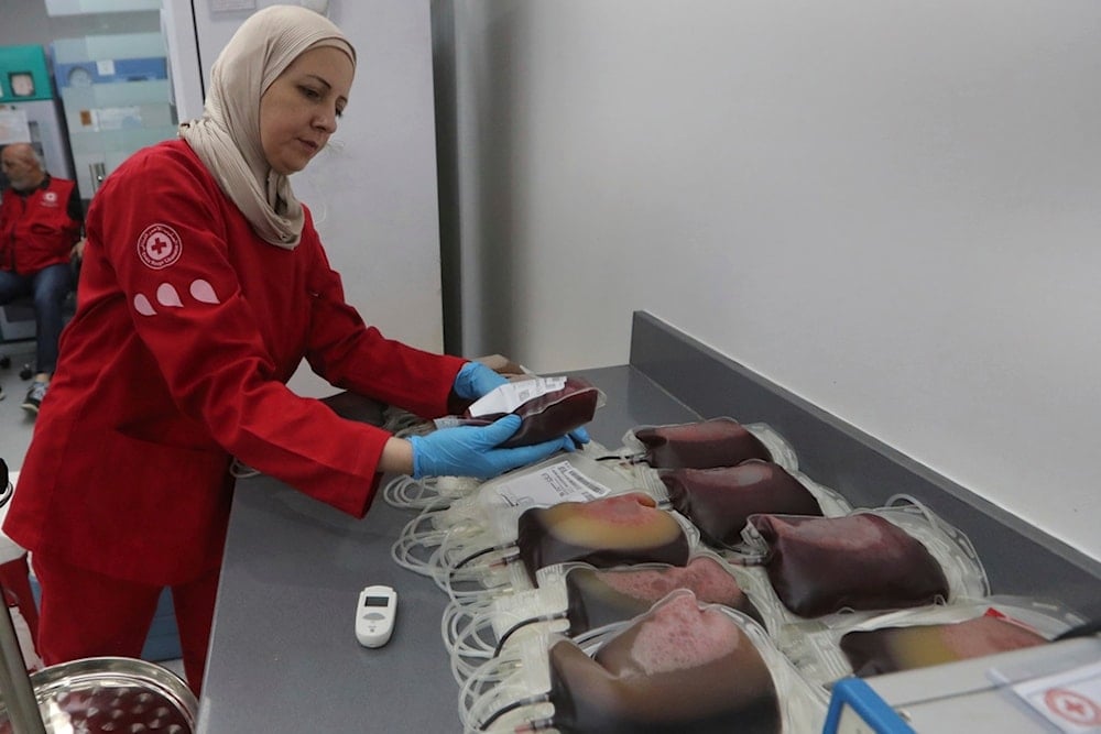 A Lebanese Red Cross volunteer collects blood donations for those who were injured by their exploded handheld pagers, Tuesday, Sept. 17, 2024, at a Red Cross center in the southern port city of Sidon, Lebanon. (AP)