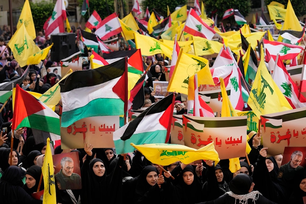 Lebanese protesters hold Hezbollah and Palestinian flags during a protest to show their solidarity with the Palestinians, in the southern suburb of Beirut, Lebanon, Oct. 13, 2023. (AP)