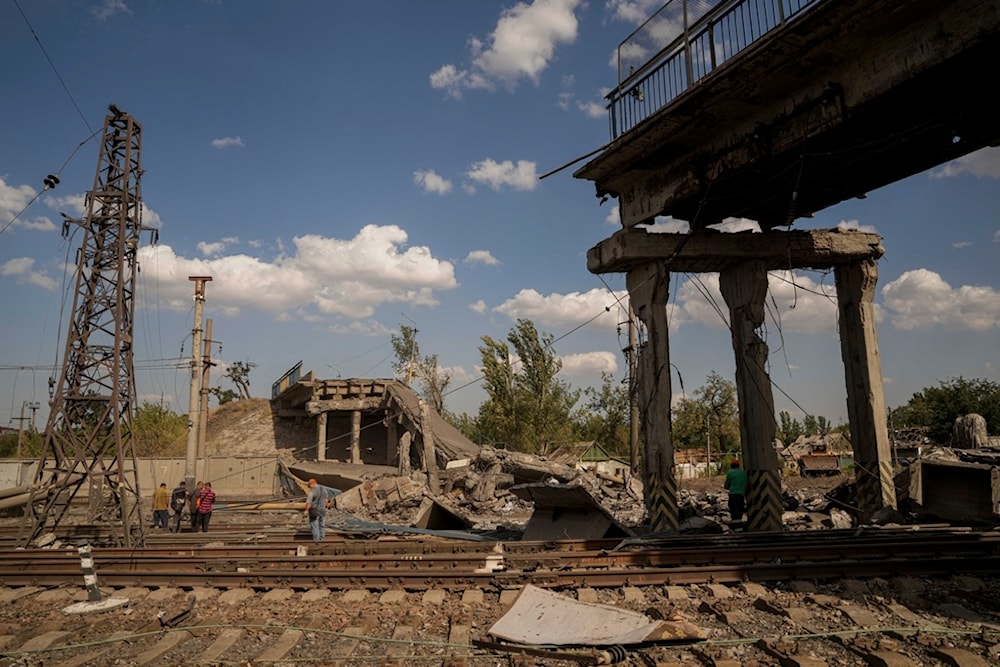 Railway workers look on the bridge destroyed by a Russian airstrike in Pokrovsk, Ukraine, Sept. 17, 2024. (AP)