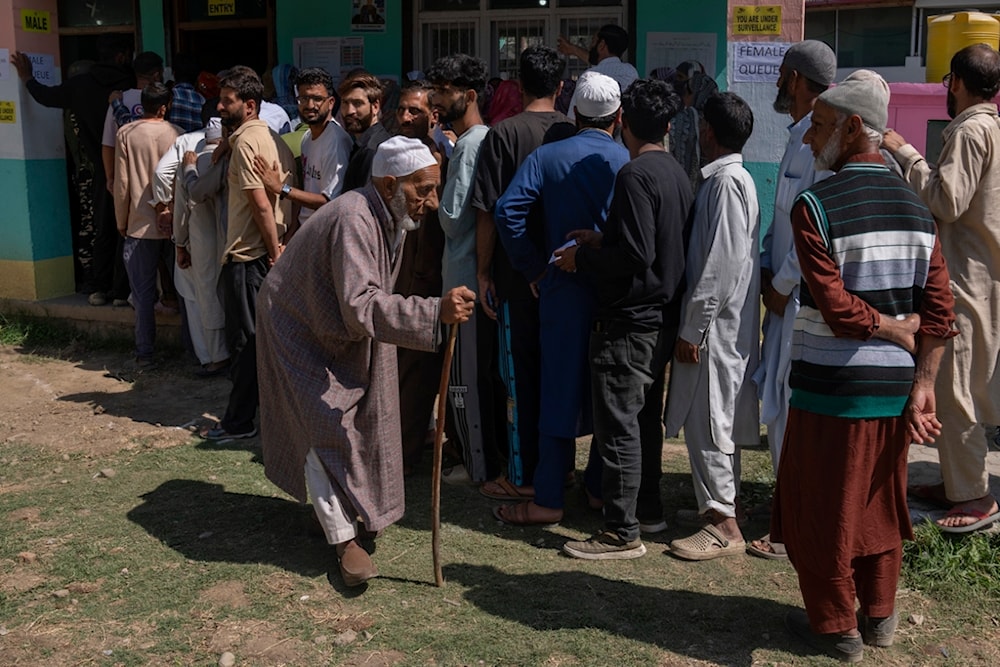 An elderly Kashmiri man walks back after casting his vote at a polling booth in in Bellow, south of Srinagar, Indian controlled Kashmir, Wednesday, Sept. 18, 2024. (AP)