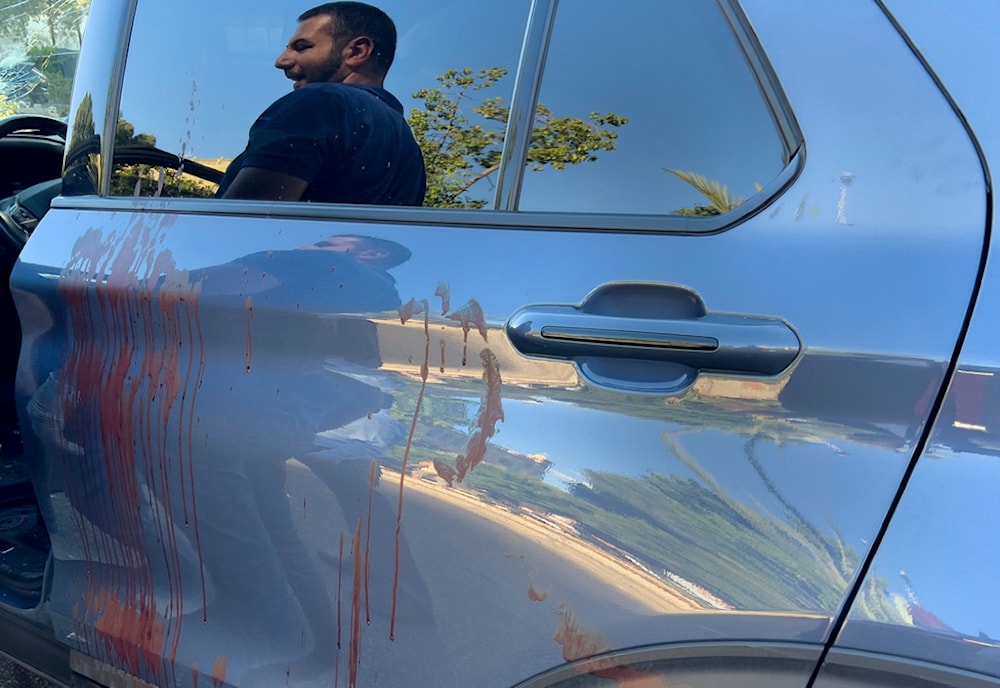 A police officer is reflected on the blood stained door of a car in which a hand-held pager exploded in Israeli terror attack, in Beirut, Lebanon, Tuesday, Sept. 17, 2024. (AP)