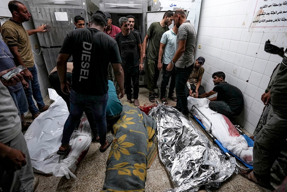 Palestinians check the bodies of their relatives killed in the Israeli bombardment of the Gaza Strip, at a hospital morgue in Deir al-Balah, Sunday, Sept. 1, 2024. (AP)