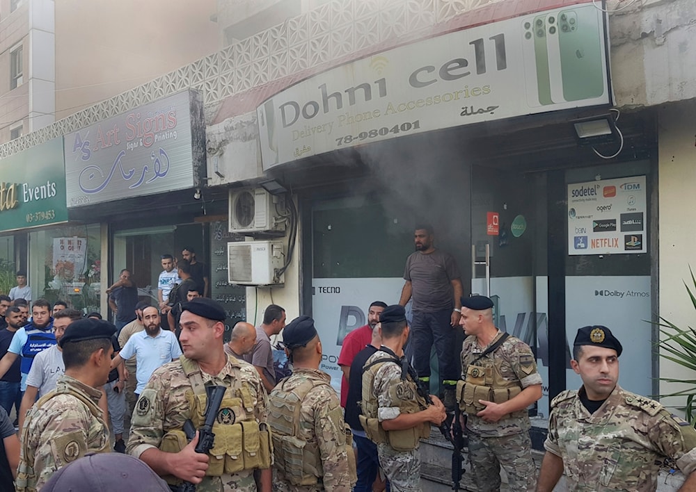 Lebanese soldiers gather outside a damaged mobile shop after a walkie-talkie exploded inside, in the southern port city of Sidon, Lebanon, Wednesday, Sept. 18, 2024. (AP)