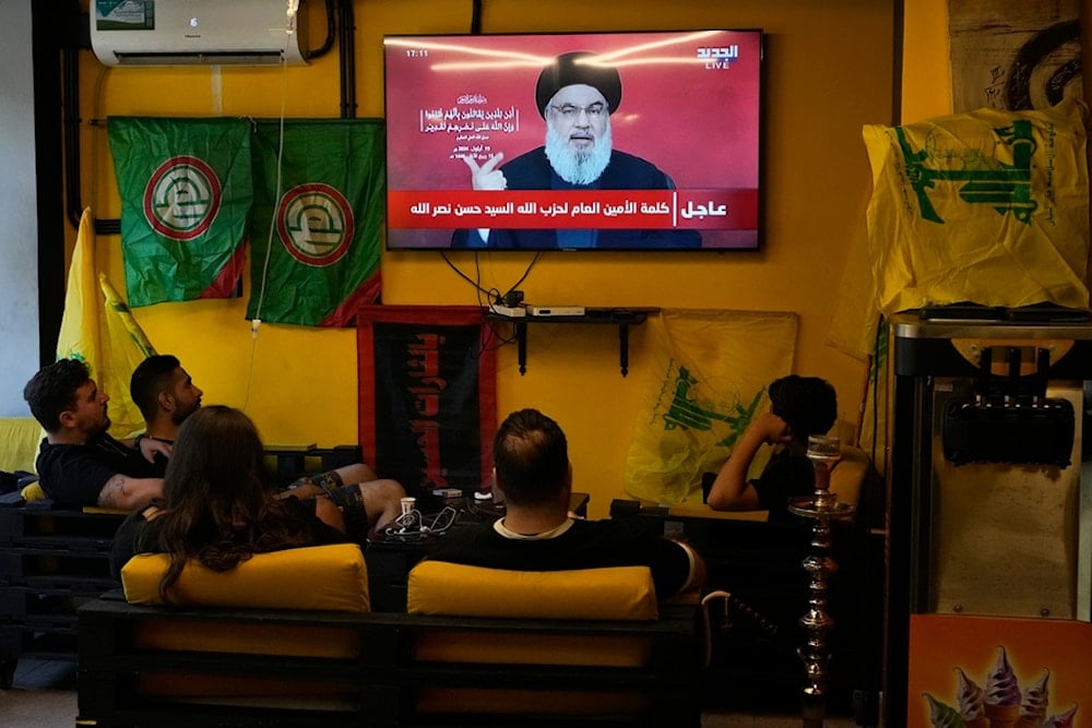 People watch the speech of Hezbollah leader Hassan Nasrallah as they sit in a cafe in the southern suburbs of Beirut, Thursday, Sept. 19, 2024 (AP Photo/Hassan Ammar)