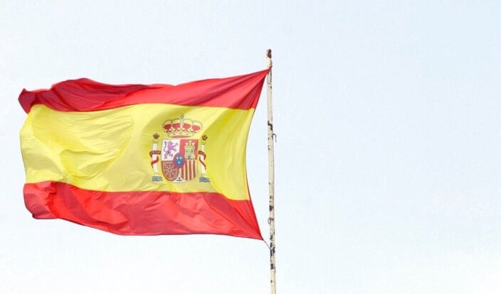  A Spanish flag flies over a military building with a symbol of the Franco era in Barcelona Thursday Oct. 11, 2007. (AP)