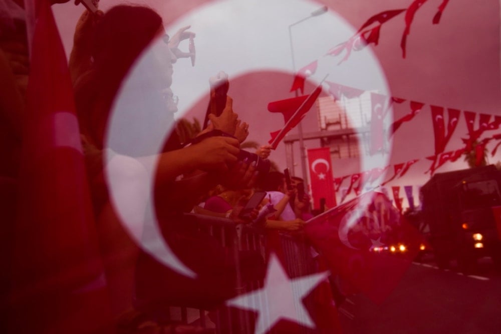 People watch Turkey's Forces parade for Victory Day, in Istanbul, Friday, Aug. 30, 2024. (AP)