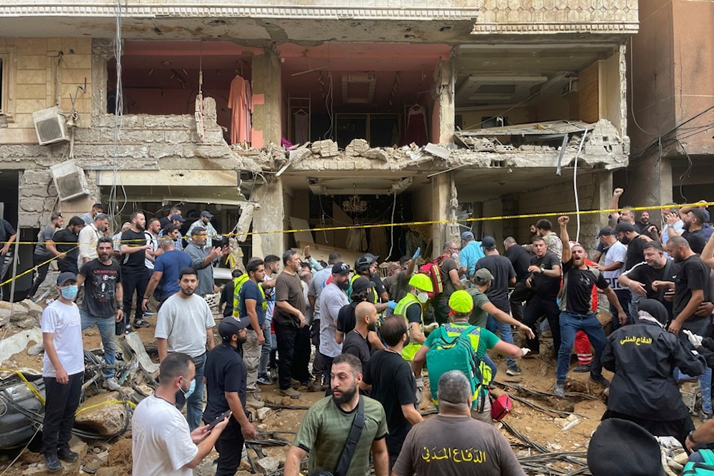 People gather near a damaged building at the scene of an Israeli missile strike in the Southern Suburb of Beirut, Friday, September 20, 2024 (AP)