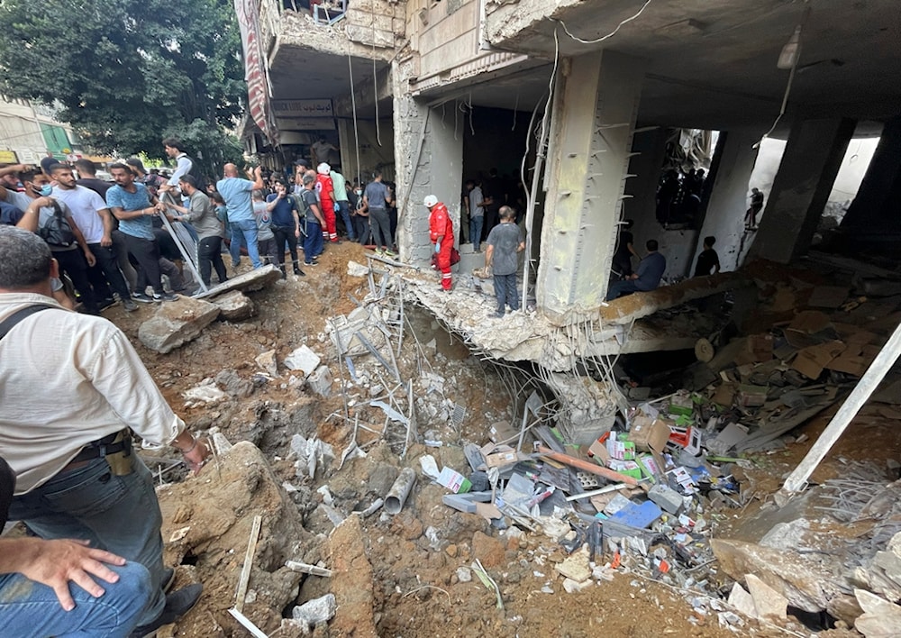 People gather at the scene of an Israeli missile strike in the southern suburbs of Beirut, Friday, Sept. 20, 2024. (AP Photo/Bilal Hussein)