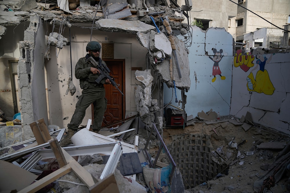 An Israeli soldier stands at the entrance of a tunnel where the military says six Israeli hostages were recently killed by Hamas militants in the southern Gaza Strip on September 13, 2024. (AP)