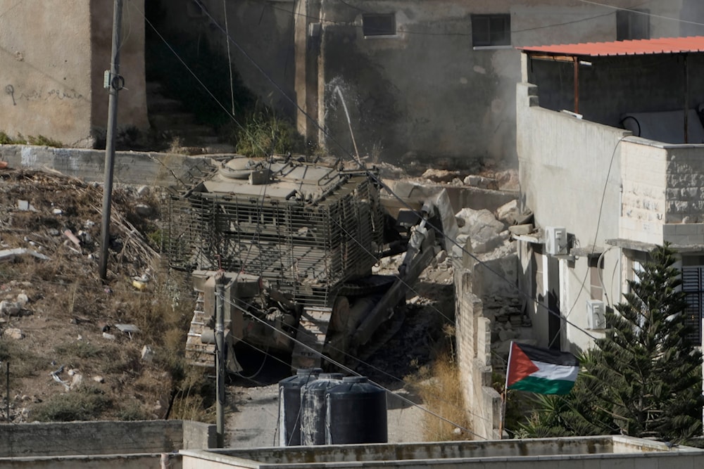 An Israeli army bulldozer moves through the West Bank town of Qabatiya during a raid, on September 19, 2024. (AP)