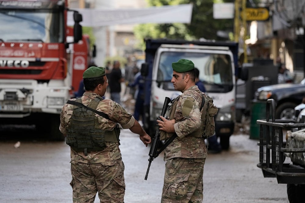 Lebanese soldiers stand guard near the site of Friday's Israeli strike in Beirut's southern suburb, on September 22, 2024. (AP)