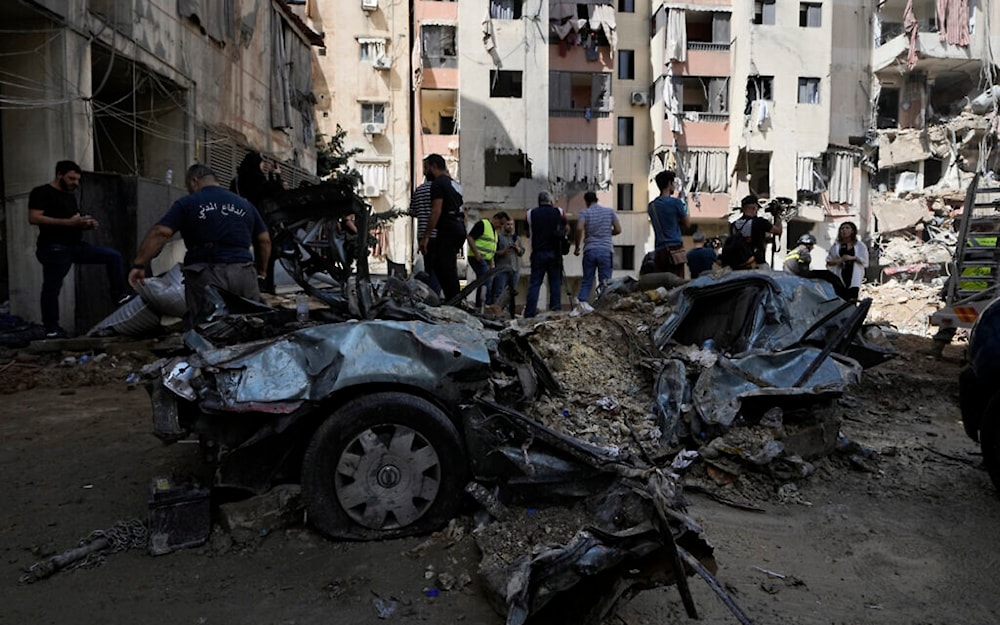 Emergency workers clear the rubble at the site of Friday's Israeli strike on Hezbollah leaders meeting in a basement in a building in Beirut's southern suburb, September 22, 2024. (AP)