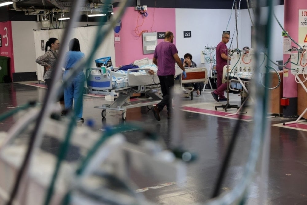 Rambam hospital workers move to a garage to work following a Hezbollah rocket attack, September 22, 2024 (AFP)