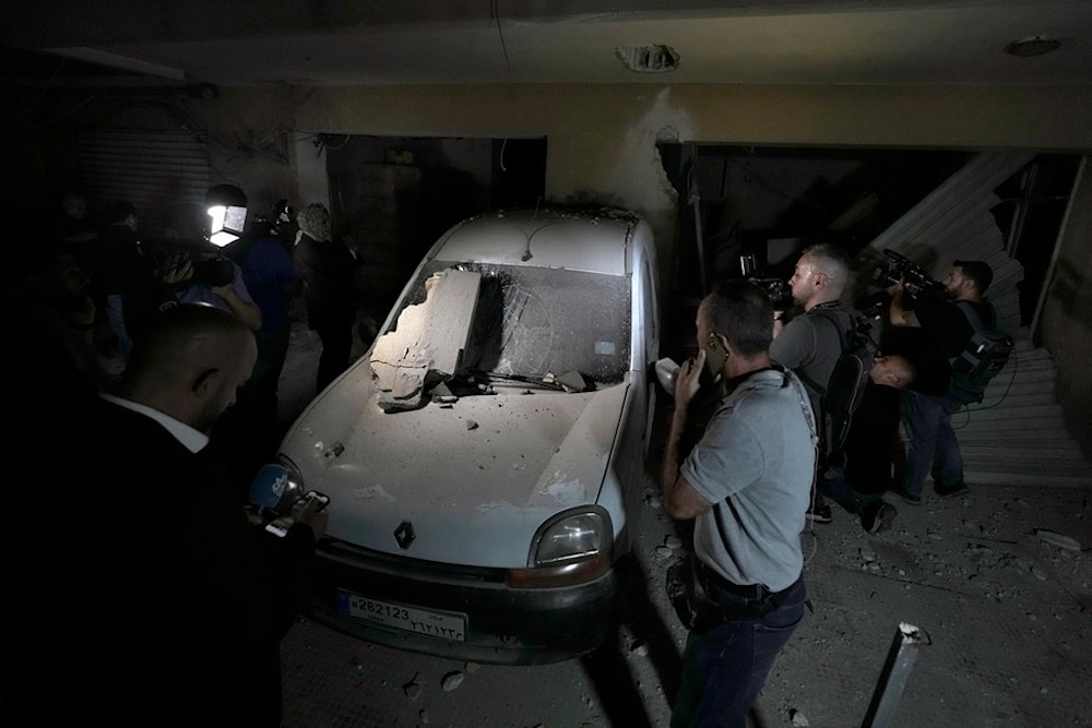 Journalists are given a tour at the site of an Israeli airstrike in Beirut's southern suburb, Monday, Sept. 23, 2024 (AP)