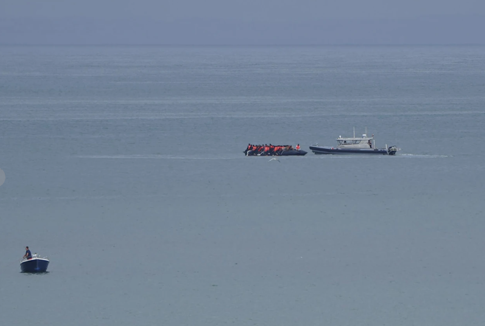 A boat tthought to be with migrants is escorted by a vessel from the French Gendarmerie Nationale off the Wimereux beach in France on September 4, 2024. (AP)