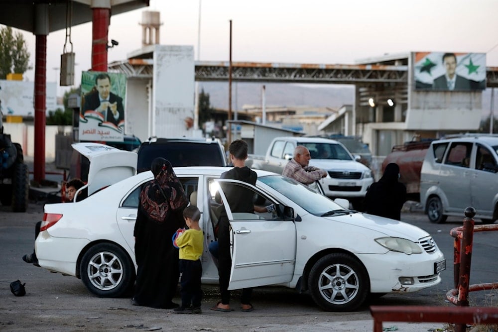 Lebanese fleeing the Israeli bombardment, arrive in a taxi at the Syrian-Lebanese border crossing in Jdaidet Yabous, Syria, Tuesday, September 24, 2024 (AP)