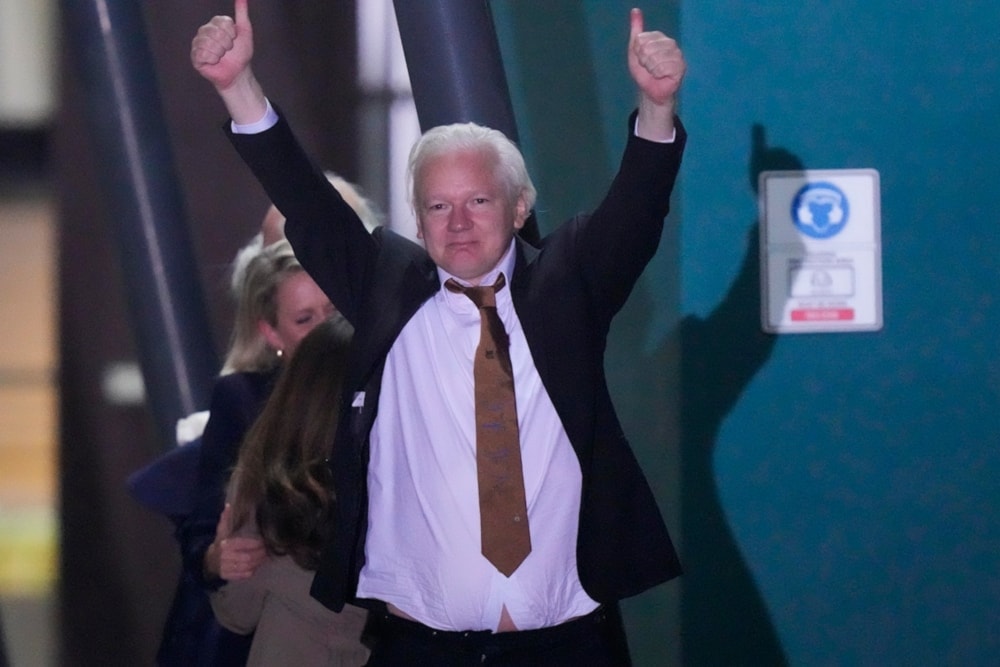 WikiLeaks founder Julian Assange gestures after landing at RAAF air base Fairbairn in Canberra, Australia, Wednesday, June 26 2024. (AP)