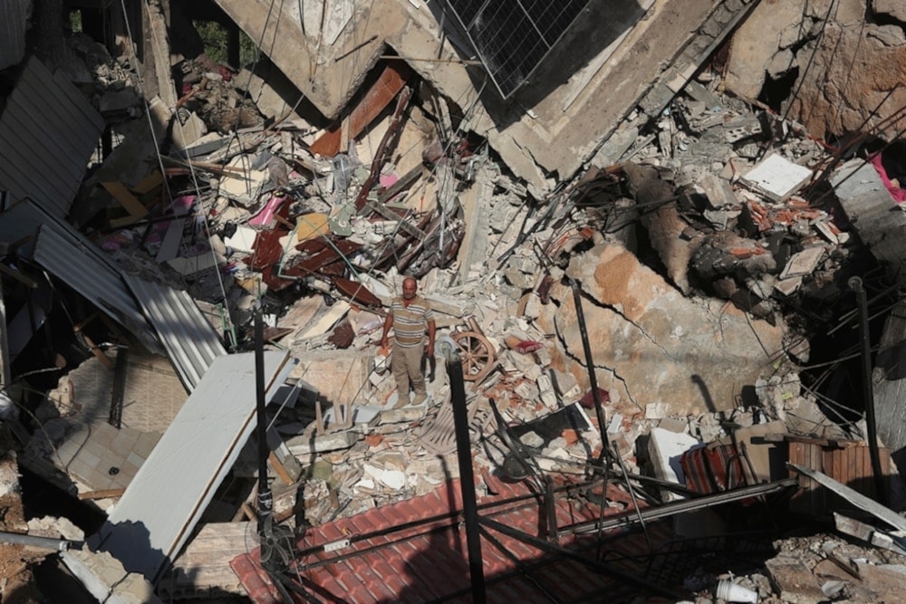   Palestinian child standing over the rubble of a building in Rafah destroyed by Israeli occupation bombing on April 21, 2024. (AFP)