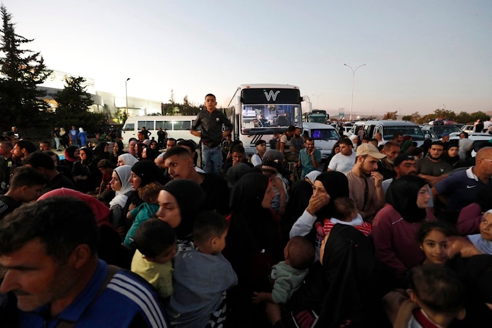 Syrians fleeing the war in Lebanon, arrive at the Syrian-Lebanese border crossing in Jdeidet Yabous, Syria, Wednesday, September 25, 2024 (AP)