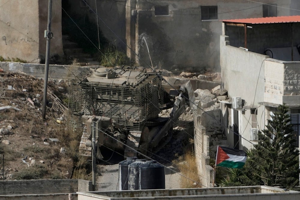 An Israeli army bulldozer moves through the West Bank town of Qabatiya during a raid, Thursday, Sept. 19, 2024. (AP Photo/Majdi Mohammed)