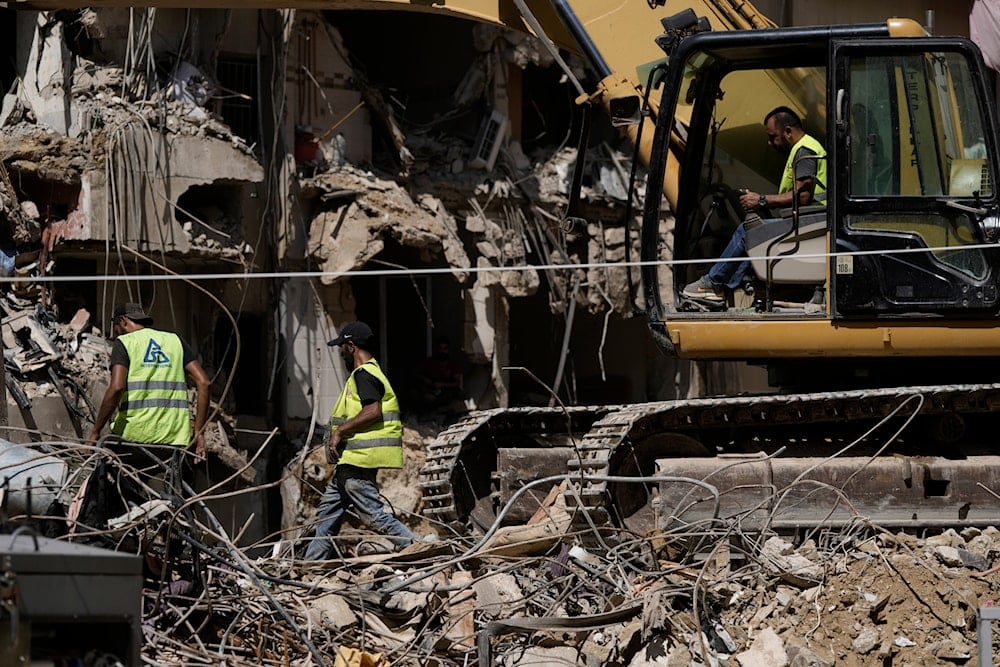 Emergency workers clear the rubble at the site of Friday's Israeli strike in Beirut's Southern Suburb, Sunday, September 22, 2024 (AP)