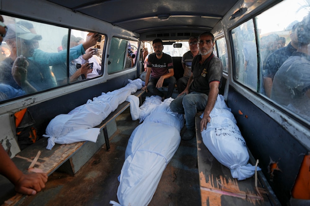 Mourners transport the bodies of their relatives killed in the Israeli bombardment of the Gaza Strip during their funeral in Deir al-Balah, Gaza, Monday, Sept. 23, 2024. (AP)