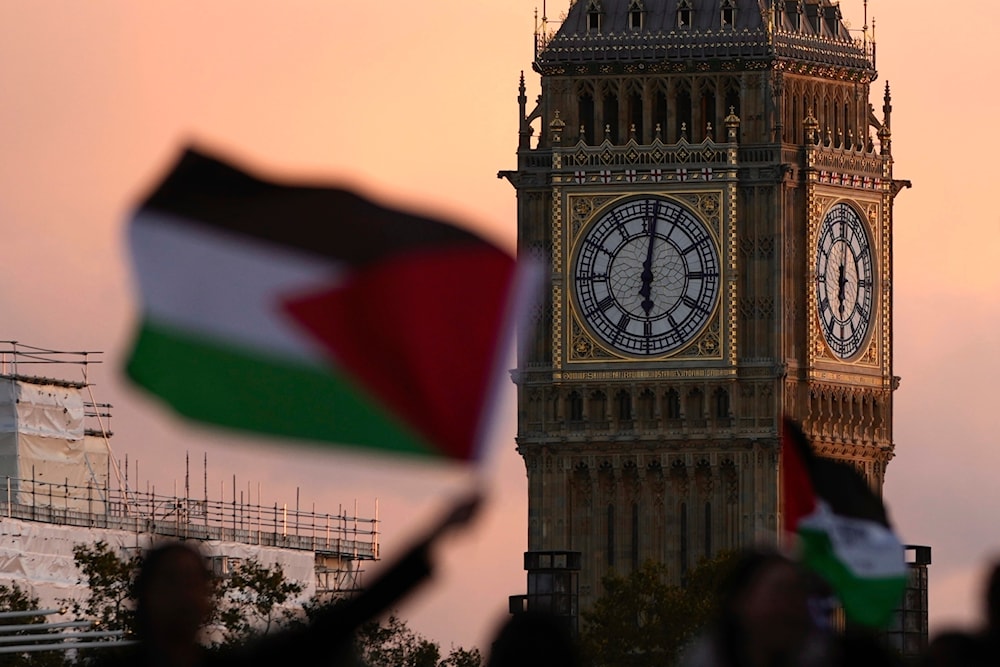 Protesters wave flags as they attend a pro Palestinian demonstration in London, Saturday, Oct. 14, 2023, (AP)