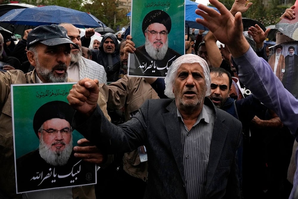 Demonstrators chant slogans as they hold posters of the leader of Lebanon's martyred Hezbollah leader Sayyed Hassan Nasrallah in the Palestine Square in downtown Tehran, Iran, Sept. 28, 2024. (AP)