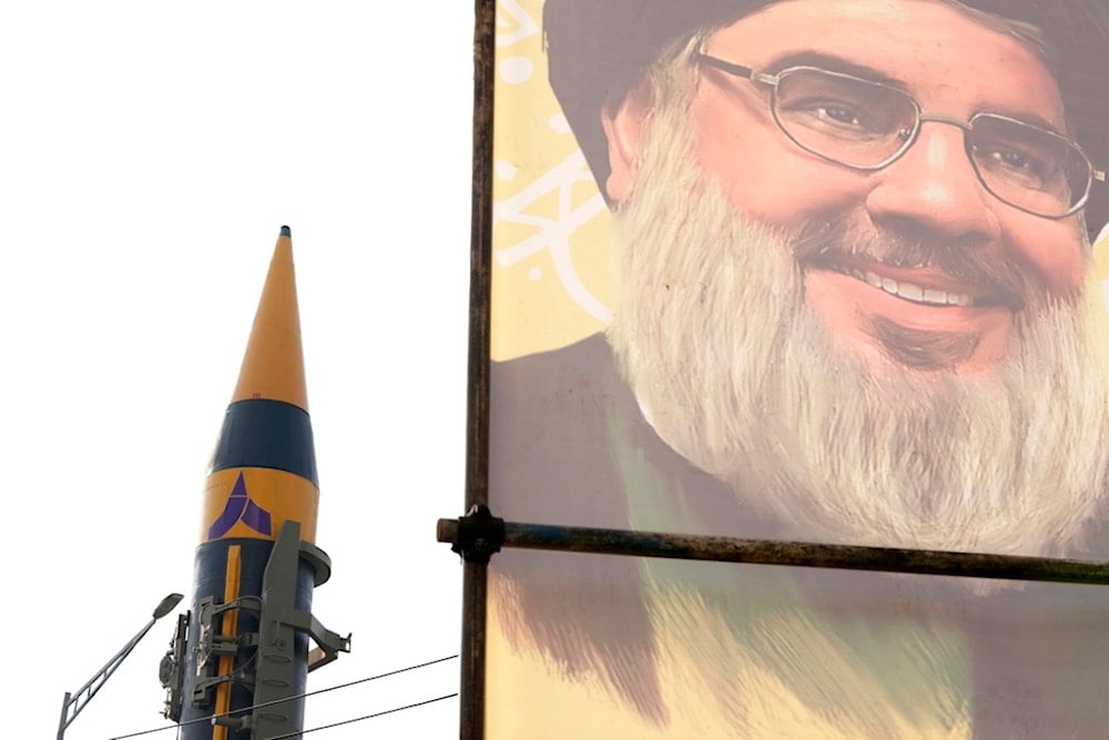 An Iranian domestically built missile is displayed in front of the portrait of the Lebanese Hezbollah leader Sayyed Hassan Nasrallah during a rally of Iran's Basij paramilitary force in support of Palestine in Iran, Nov. 24, 2023. (AP)