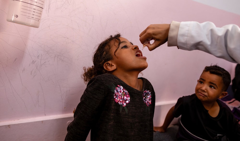 A nurse administers Polio vaccine drops to a young Palestinian patient at the Nasser hospital in Khan Yunis in the southern Gaza Strip on August 31, 2024. (AFP)