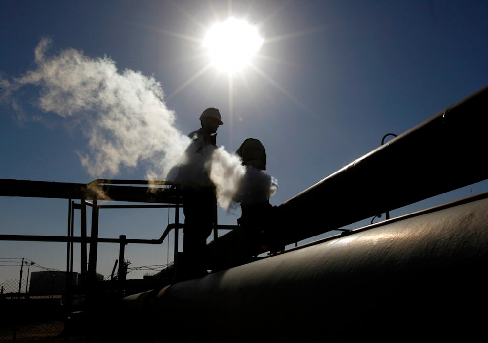 In this Feb. 26, 2011 file photo, a Libyan oil worker, works at a refinery inside the Brega oil complex, in Brega, eastern Libya. (AP)