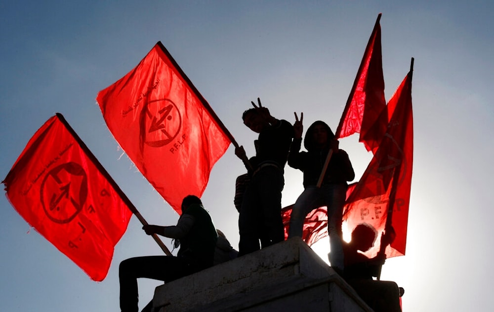 Palestinians wave flags during a rally marking the 45th anniversary of the Popular Front for the Liberation of Palestine (PFLP), in Gaza City, Thursday, Dec. 6, 2012. (AP)