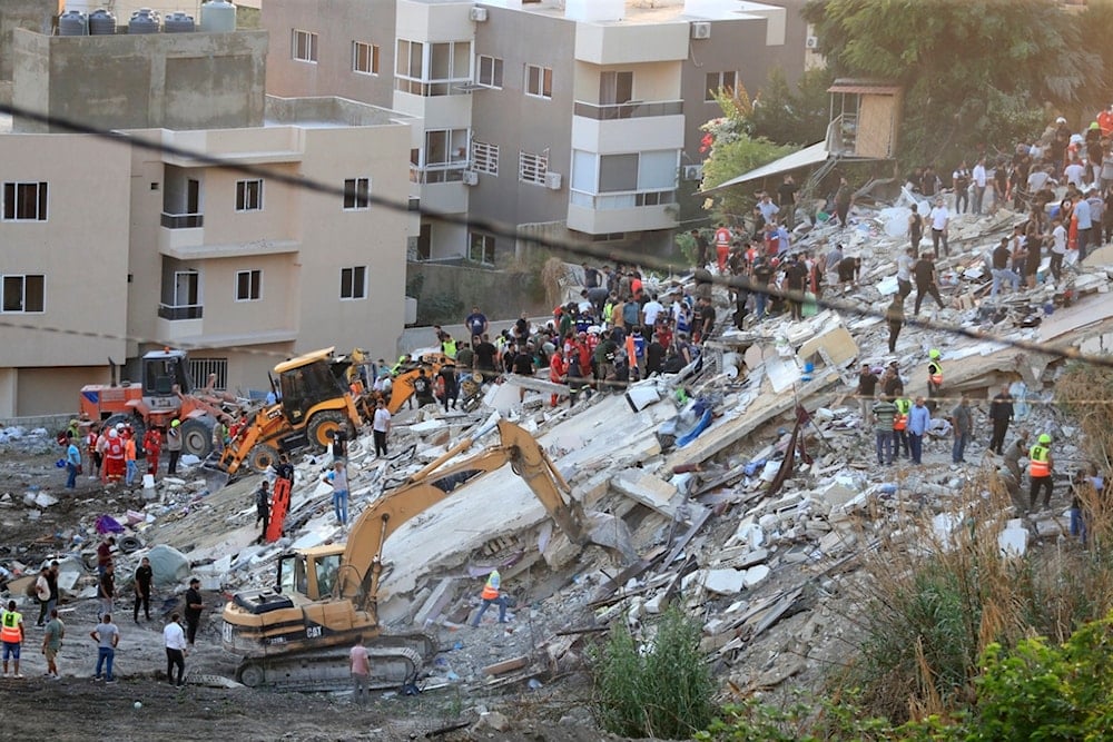 People and rescue teams search for victims after an Israeli airstrike hit two adjacent buildings, in Ain el-Delb neighborhood east of the southern port city of Saida, Lebanon, Sept. 29, 2024. (AP)