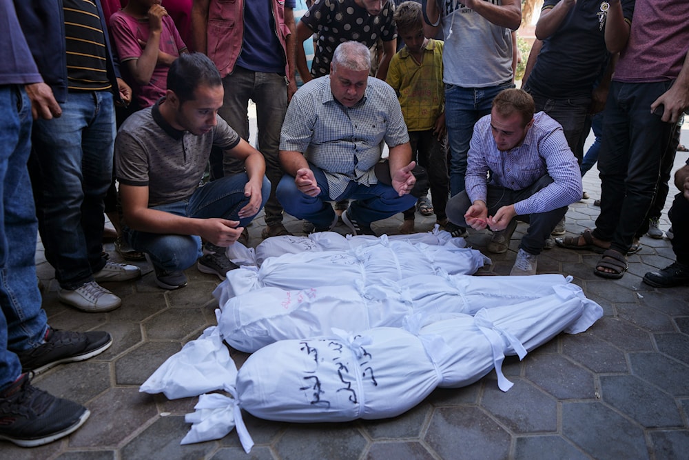 Palestinians mourn their relatives, including kids killed in the Israeli bombardment of the Gaza Strip, outside a morgue in Deir al-Balah, Gaza, September 23, 2024. (AP)