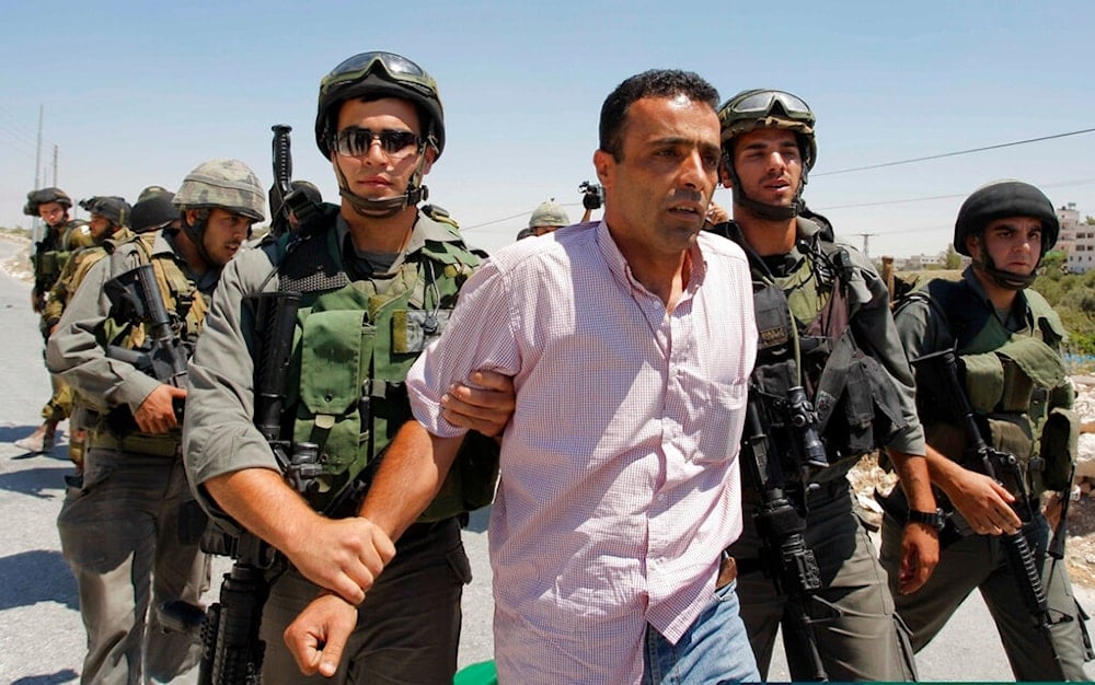 A Palestinian protester is detained during a demonstration against the Israeli separation barrier in the West Bank village of Maasarah, July 16, 2010. (AP)