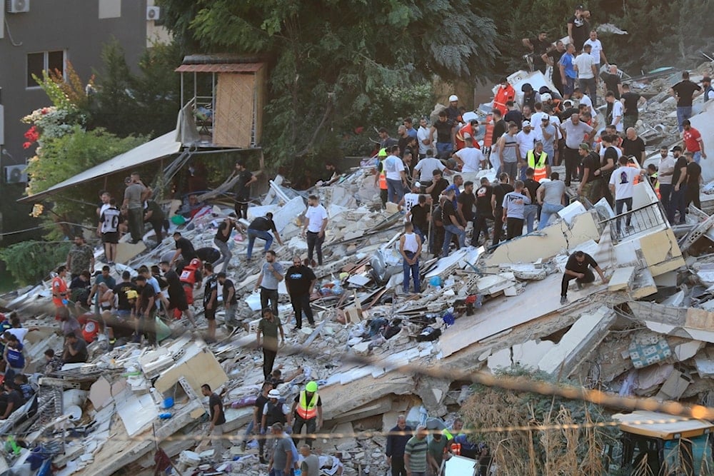 People and rescue workers search for victims after an Israeli airstrike hit two adjacent buildings, in Ain el-Delb neighborhood east of the southern port city of Sidon, Lebanon, Sunday, September 29, 2024 (AP)