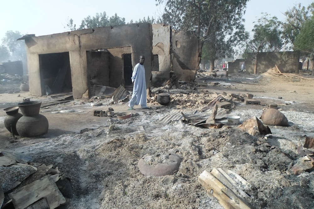 A man walks past burnt out houses following an attack by Boko Haram in Dalori village near Maiduguri, Nigeria, on January 31, 2016. (AP)