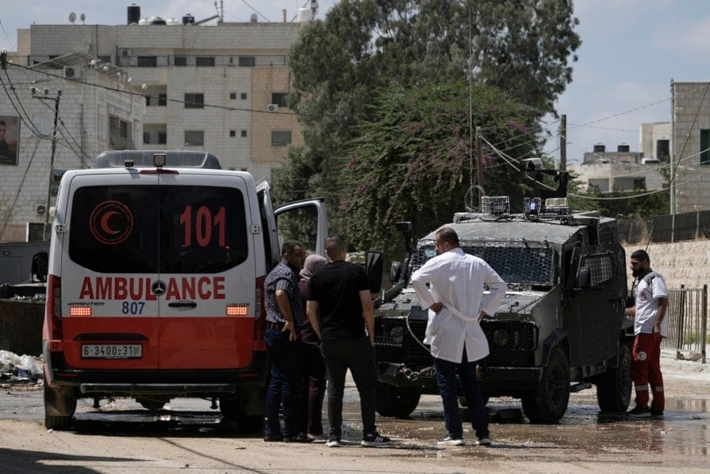 Israeli occupation forces stop an ambulance and check documents from the Palestinians during an aggression on the West Bank city of Jenin, Palestine, on August 30, 2024. (AP)