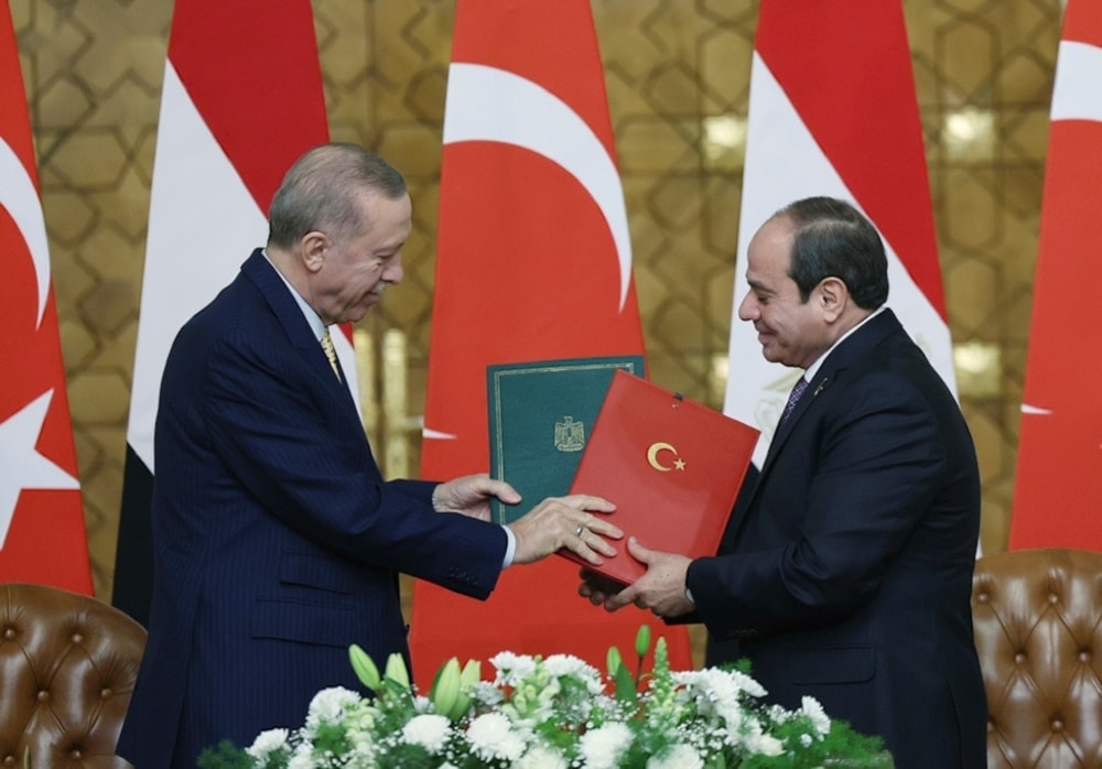 Egyptian President Abdel Fattah el-Sisi and Turkish President Recep Tayyip Erdogan exchange signed agreements following their meeting in Cairo, Egypt. Feb. 14, 2024 (AP)