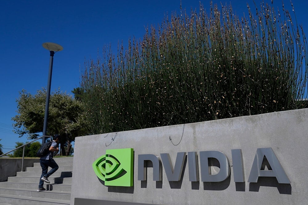 A person walks past a sign outside of a Nvidia office building in Santa Clara, Calif., on August 7, 2024. (AP)