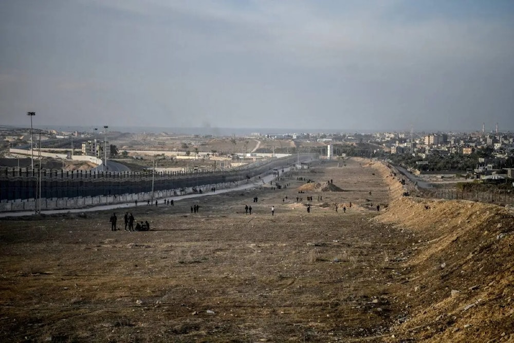 Palestinians are seen at the Egypt-Gaza border as they continue their daily lives under harsh conditions in Rafah, Gaza on January 18, 2024. (AP)