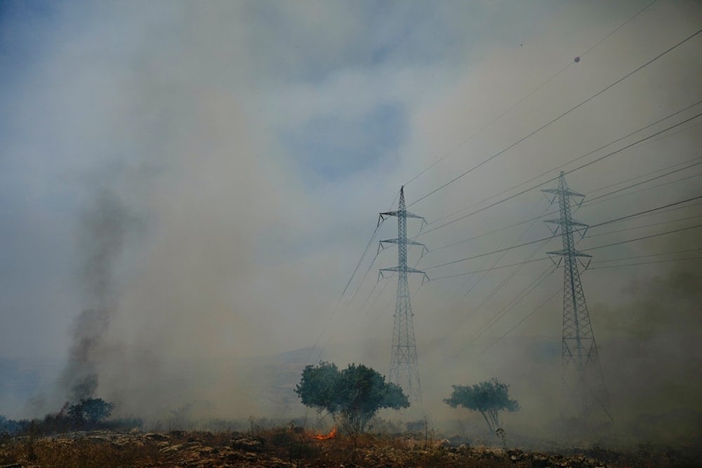 Fire burns near electricity pylons located close to the community of Ramot Naftali, by the border with Lebanon, northern occupied Palestine, Tuesday, June 4, 2024 (AP)